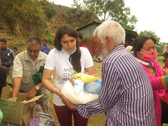 Mobile Helpdesk volunteer assisting Nepali man after the earthquake