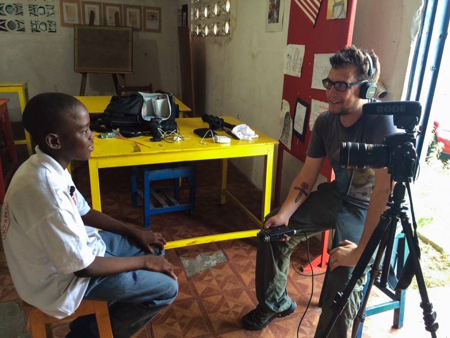 Jim Tuttle (right) interviews a student of the Liberia Visual Arts Academy.