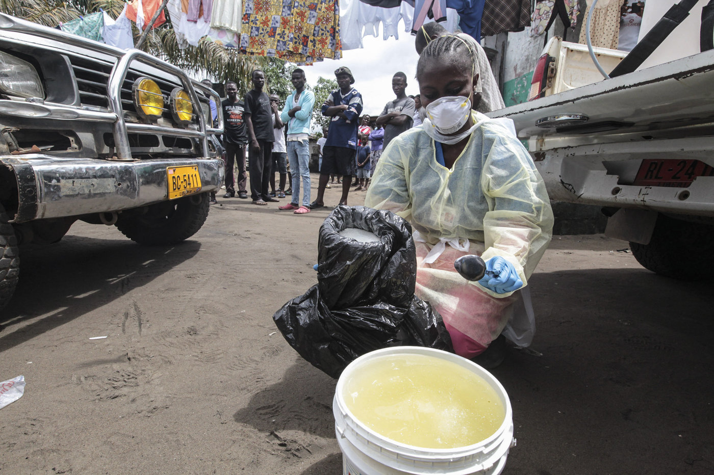 Garmai Sumo mixes chlorine with water to disinfect a residential area in Monrovia, Liberia, where a resident died of Ebola on Oct. 14, 2014.