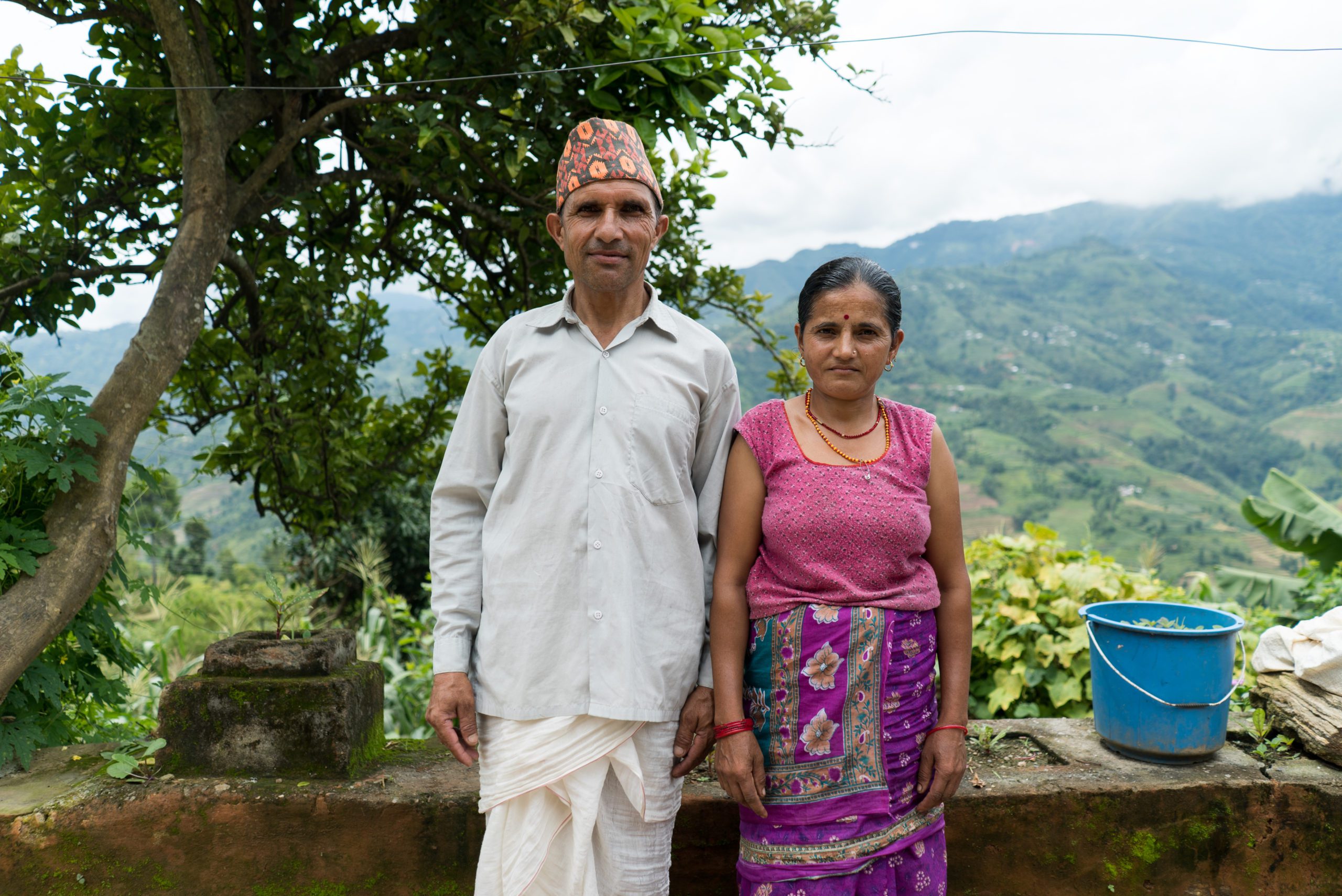 Bhartman Sigdel along with his wife Devaki Sigdel pose for a portrait outside their home in Sindhukot, Sindhupalchowk district. They are currently living in a temporary shelter as their house was damaged in the 2015 earthquake.