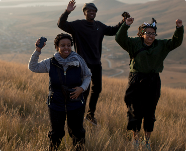 Young people celebrating in a field